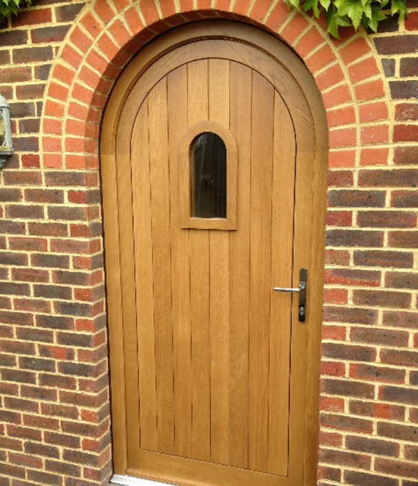 Wooden door with small arch window